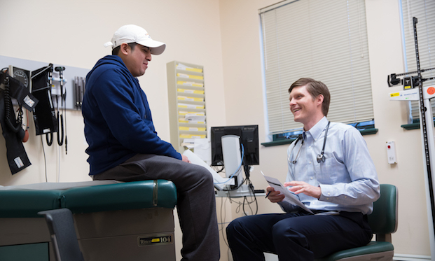 Lawrence Family Medicine Residency graduate Dr. Jonathan Lichkus treats a patient at GLFHC Haverhill Street location.