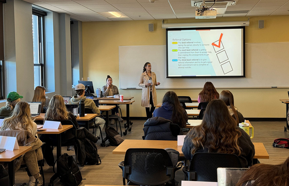 Lucia Rondon, Project Coordinator for GLFHC's Recovery-Based Re-Entry Services Program, instructs Merrimack College students on the suicide prevention training program QPR (Question, Persuade and Refer).